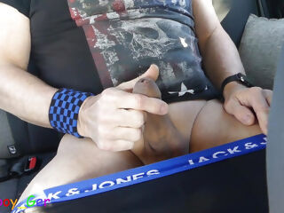 Jerking off, vibrator on the cock and lots of precum in the back seat of the car in a parking lot.